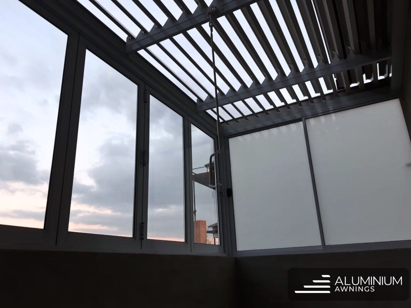 Motorised charcoal aluminium louvre awning — Melkbosstrand, Cape West Coast