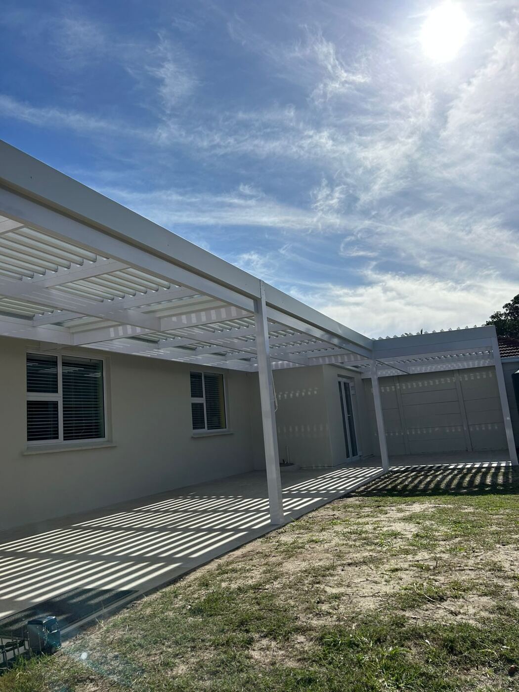 The white louvre awning seen from the garden in Bellville.