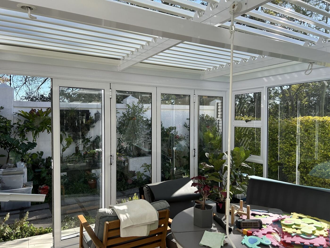 White frame & blades aluminium louvre roof over a patio in Constantia, Cape Town.
