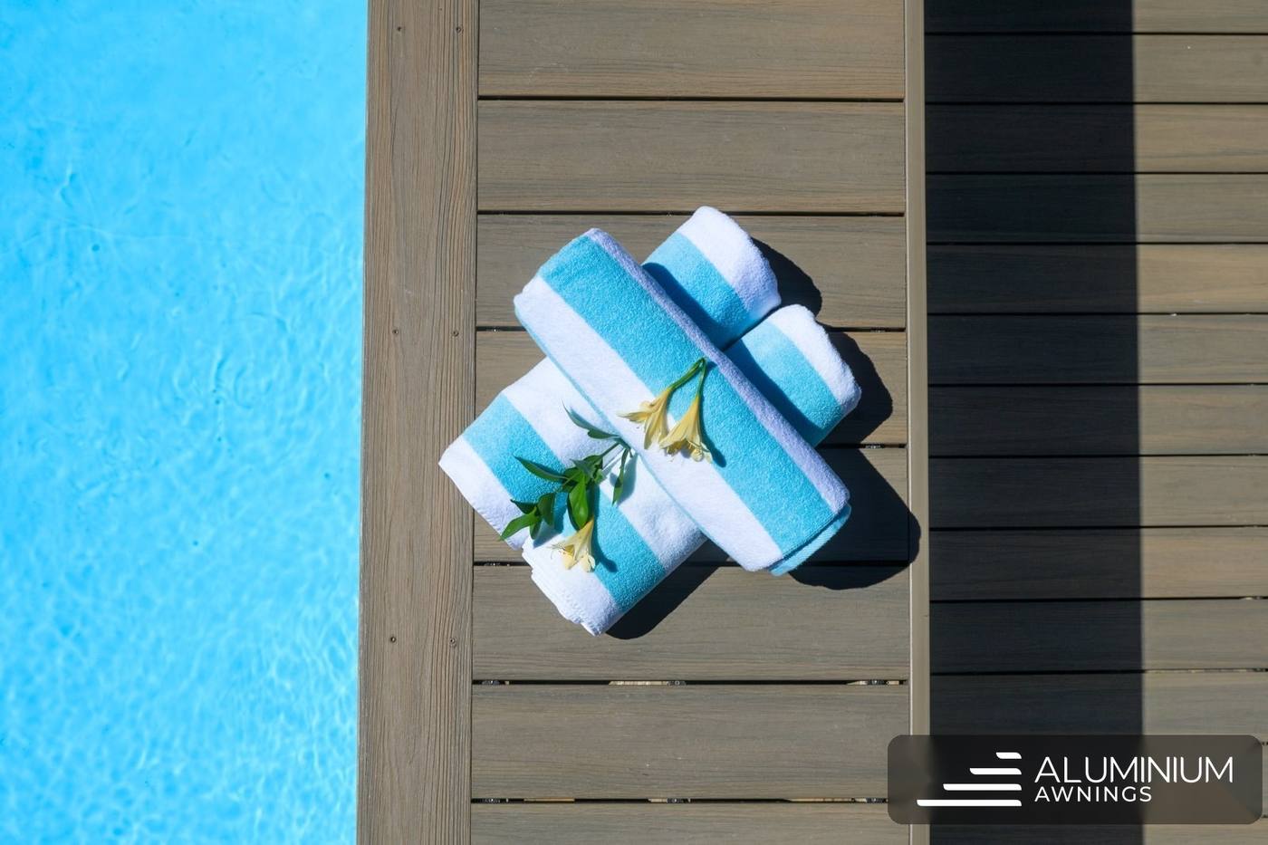Two-tone wood-grain composite boards beside a pool
