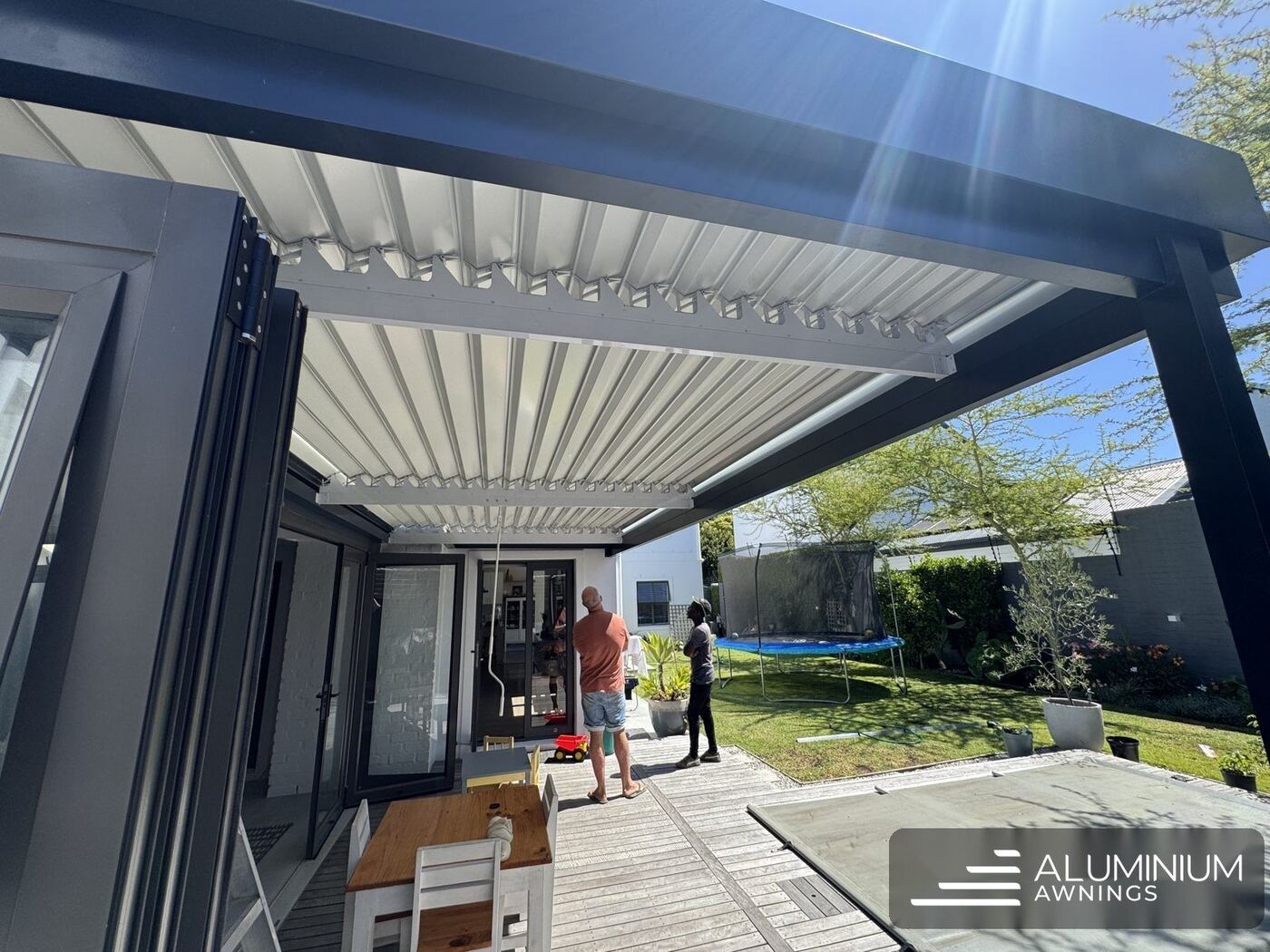 Charcoal aluminium louvre roof over a patio — Claremont, Cape Town