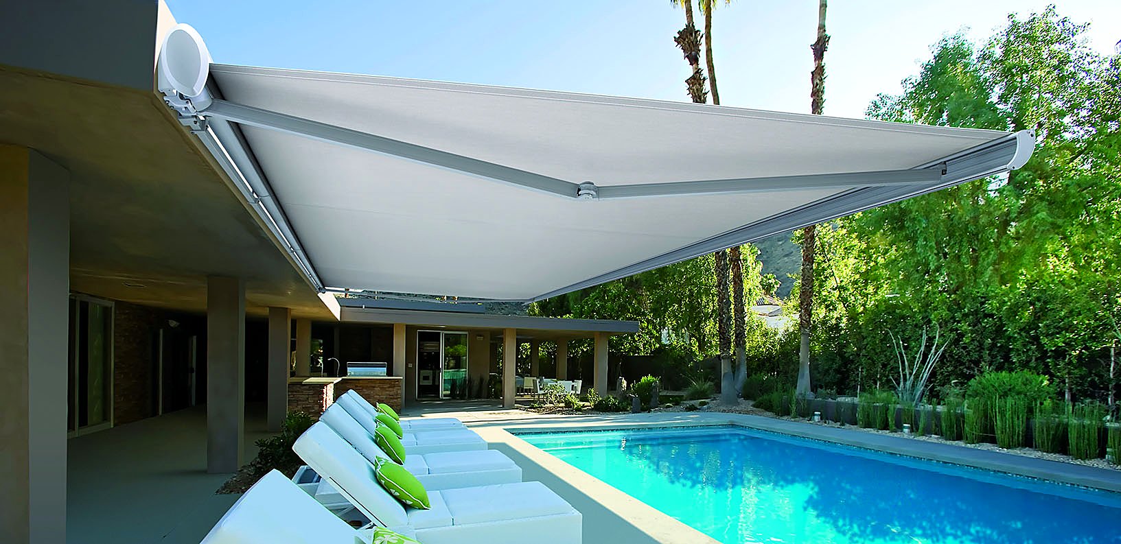 Cassette awning extended over a poolside lounging deck
